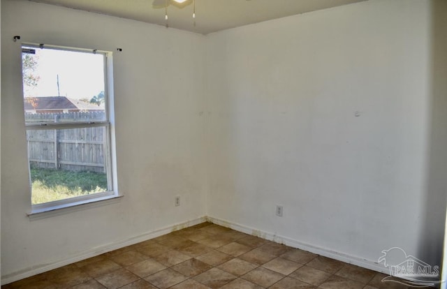 spare room featuring a wealth of natural light and ceiling fan