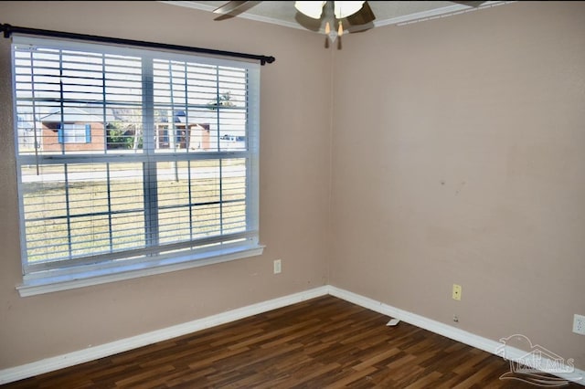 spare room with dark hardwood / wood-style flooring, ceiling fan, and crown molding