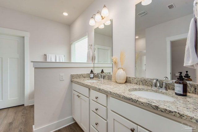 bathroom with hardwood / wood-style floors and vanity