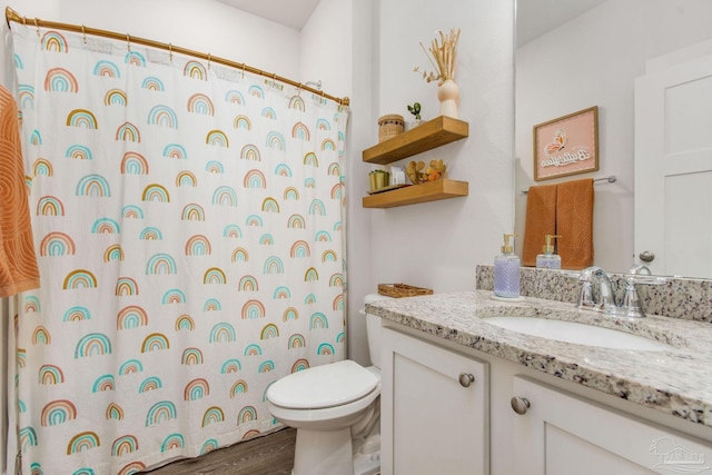 bathroom featuring vanity, hardwood / wood-style flooring, toilet, and walk in shower