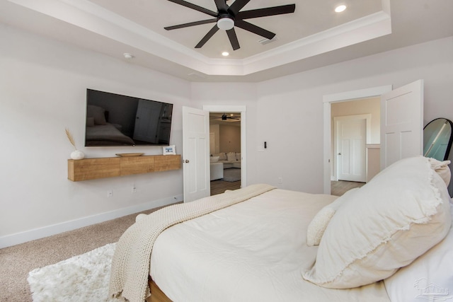 bedroom featuring carpet flooring, a tray ceiling, and ceiling fan