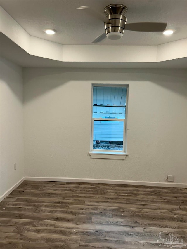 empty room with dark hardwood / wood-style flooring