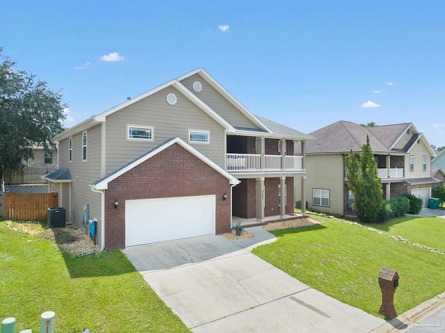 view of front of house featuring a balcony, a garage, central AC unit, and a front yard