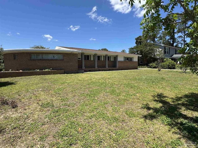 ranch-style home with brick siding and a front lawn
