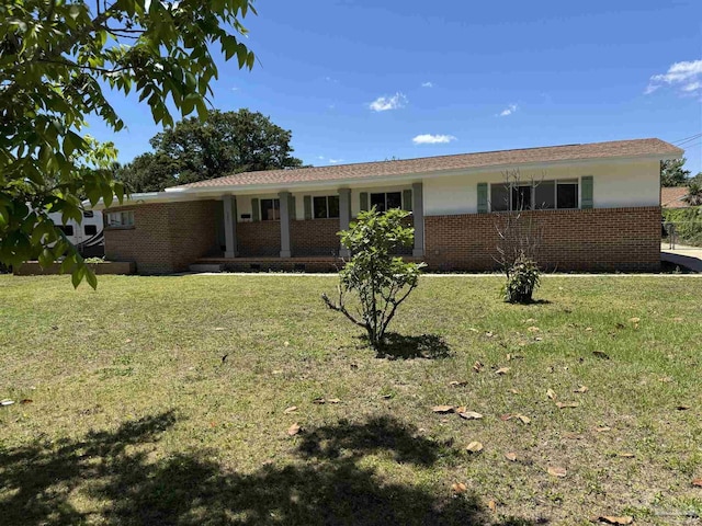 ranch-style home with brick siding and a front lawn