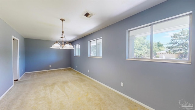 unfurnished room featuring baseboards, visible vents, and light colored carpet