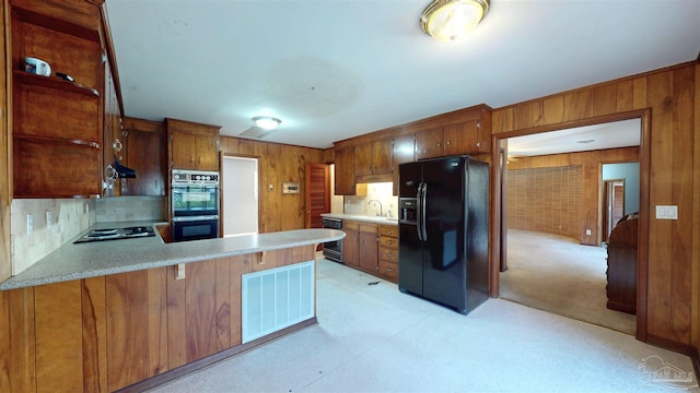 kitchen featuring visible vents, light countertops, a sink, and black appliances