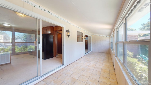 unfurnished sunroom with tile patterned floors