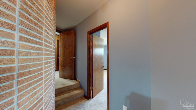 hallway featuring stairway and light colored carpet