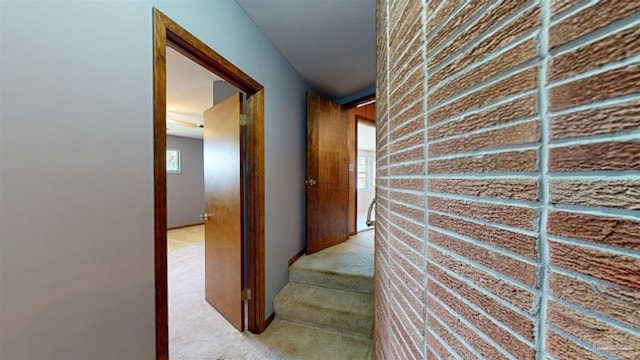 hall with light colored carpet