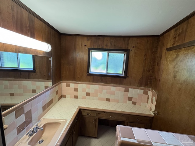 bathroom with a sink, tile patterned flooring, and tasteful backsplash