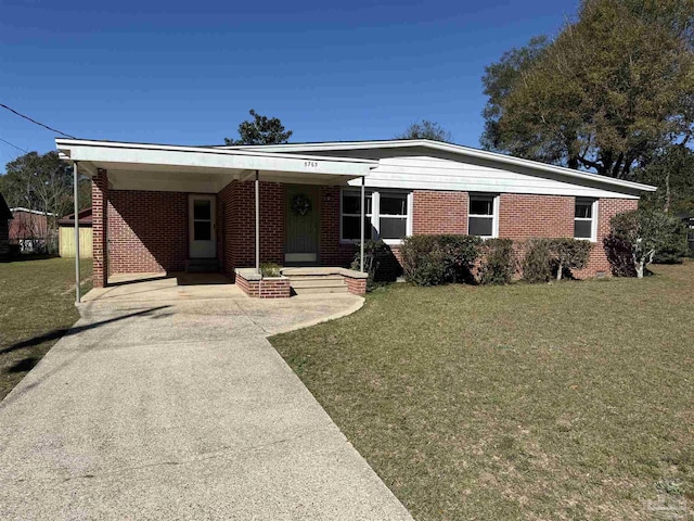 ranch-style house featuring concrete driveway, brick siding, a front yard, and an attached carport