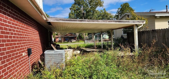 exterior space with central air condition unit and a carport