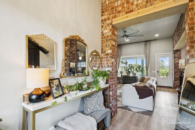 7664 Buffalo Ridge Rd, Pace, FL 32571 - living area featuring wood finished floors, a ceiling fan, and brick wall