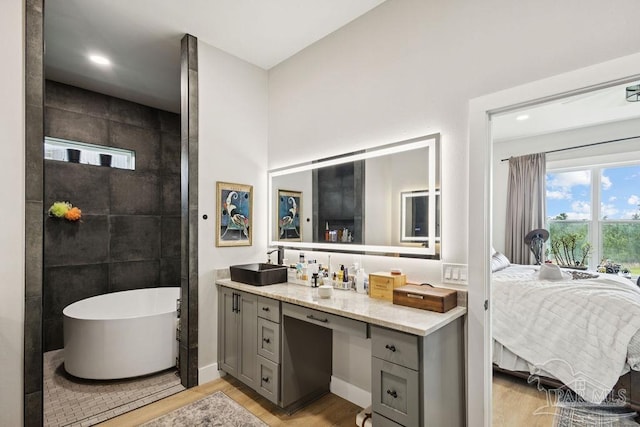 7664 Buffalo Ridge Rd, Pace, FL 32571 - full bathroom featuring a freestanding tub, wood finished floors, vanity, connected bathroom, and recessed lighting