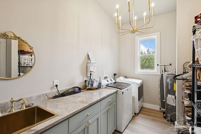 7664 Buffalo Ridge Rd, Pace, FL 32571 - washroom with washing machine and dryer, cabinet space, electric water heater, a chandelier, and light wood-type flooring