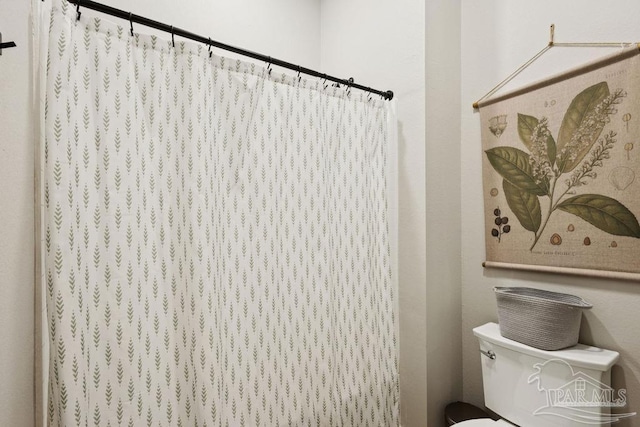 7664 Buffalo Ridge Rd, Pace, FL 32571 - bathroom with toilet and a shower with shower curtain