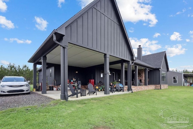 7664 Buffalo Ridge Rd, Pace, FL 32571 - back of house with board and batten siding, a yard, a chimney, and a shingled roof