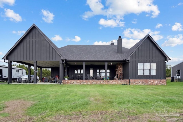 7664 Buffalo Ridge Rd, Pace, FL 32571 - back of house featuring board and batten siding, a chimney, a yard, and a shingled roof