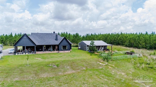 7664 Buffalo Ridge Rd, Pace, FL 32571 - rear view of property with a chimney, a yard, and roof with shingles