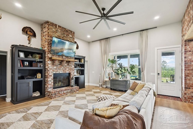 7664 Buffalo Ridge Rd, Pace, FL 32571 - living area with ceiling fan, light wood-style floors, a fireplace, and recessed lighting