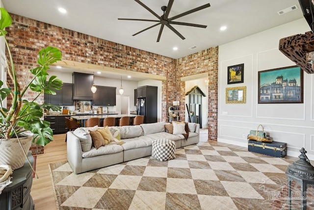 7664 Buffalo Ridge Rd, Pace, FL 32571 - living area with ceiling fan, recessed lighting, and brick wall