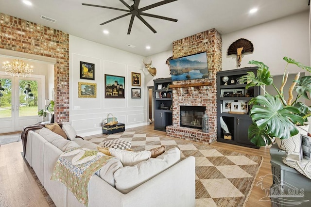 7664 Buffalo Ridge Rd, Pace, FL 32571 - living room featuring a ceiling fan, a brick fireplace, wood finished floors, a chandelier, and recessed lighting