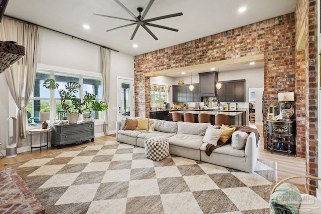 7664 Buffalo Ridge Rd, Pace, FL 32571 - living area featuring a ceiling fan, recessed lighting, light wood-style floors, and a high ceiling