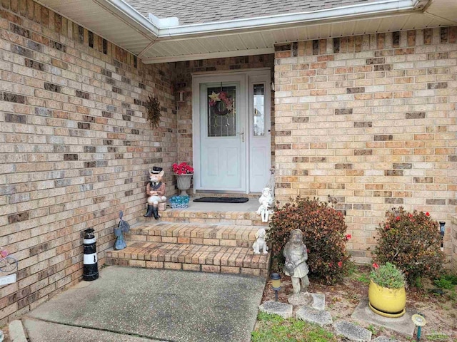 entrance to property with brick siding and roof with shingles