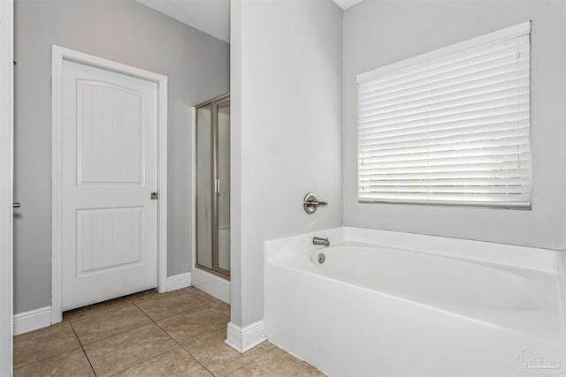 bathroom with tile patterned flooring and plus walk in shower