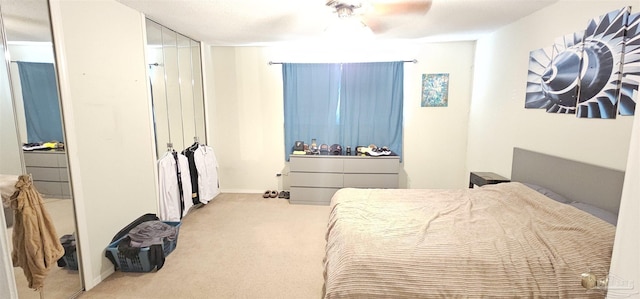 bedroom featuring light colored carpet and ceiling fan