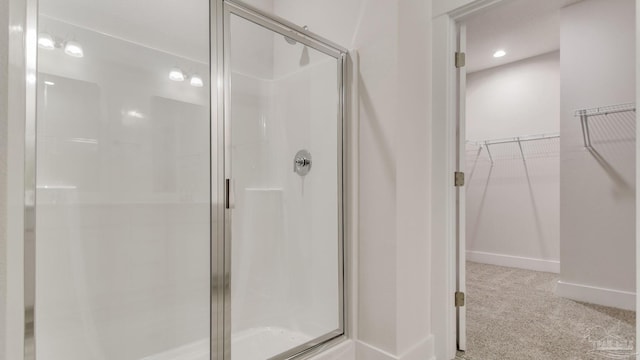 1674 Amaya Ln, Gulf Breeze, FL 32563 - full bathroom featuring a stall shower, baseboards, a walk in closet, and recessed lighting