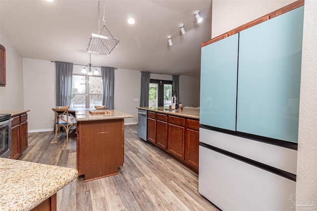 kitchen featuring dishwasher, french doors, light stone counters, pendant lighting, and a kitchen island