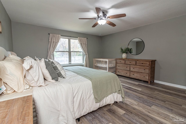 bedroom with ceiling fan and dark wood-type flooring