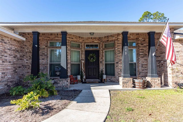 view of exterior entry with a porch