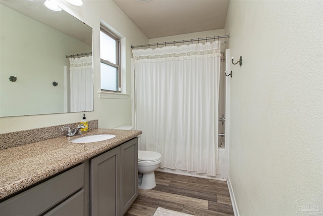 full bathroom featuring hardwood / wood-style floors, vanity, toilet, and shower / bathtub combination with curtain