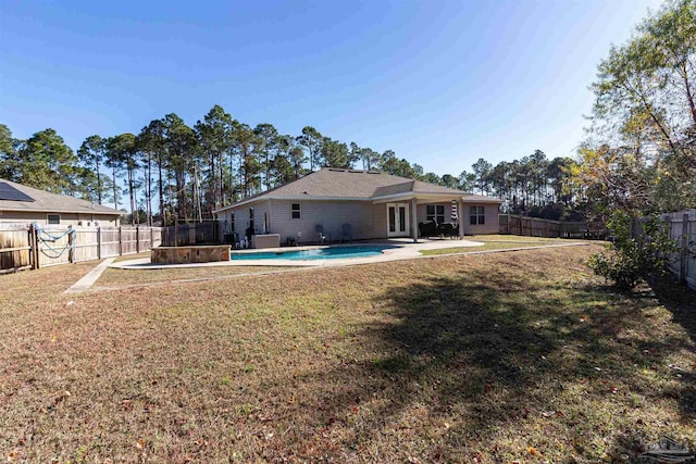 view of yard featuring a fenced in pool, a patio, and a trampoline