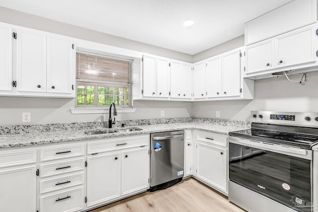 9001 Thompson Dr, Pensacola, FL 32534 - kitchen with appliances with stainless steel finishes, a sink, white cabinetry, and light wood-style floors