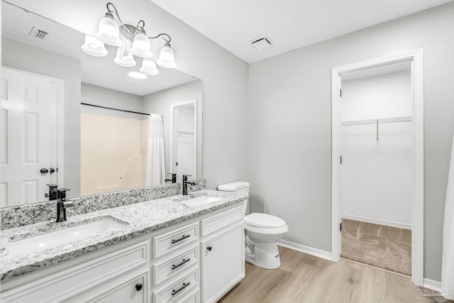 9001 Thompson Dr, Pensacola, FL 32534 - full bath with wood finished floors, a chandelier, toilet, a walk in closet, and curtained shower