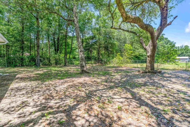 9001 Thompson Dr, Pensacola, FL 32534 - view of yard featuring fence and a view of trees