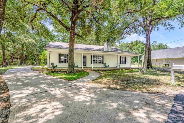 9001 Thompson Dr, Pensacola, FL 32534 - single story home featuring a porch and a chimney