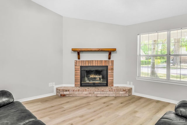9001 Thompson Dr, Pensacola, FL 32534 - living area featuring wood finished floors, baseboards, and a fireplace