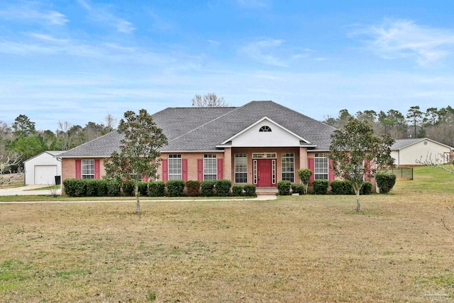 ranch-style home featuring a garage and a front lawn