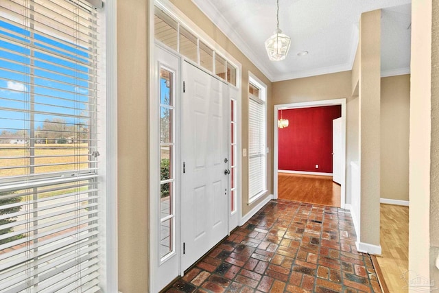 foyer entrance featuring ornamental molding