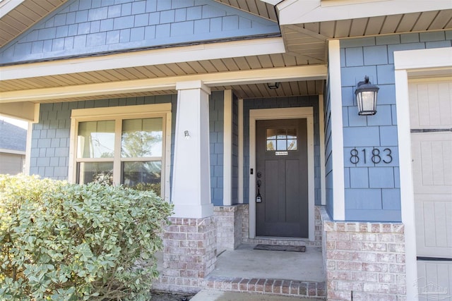 view of exterior entry with a porch