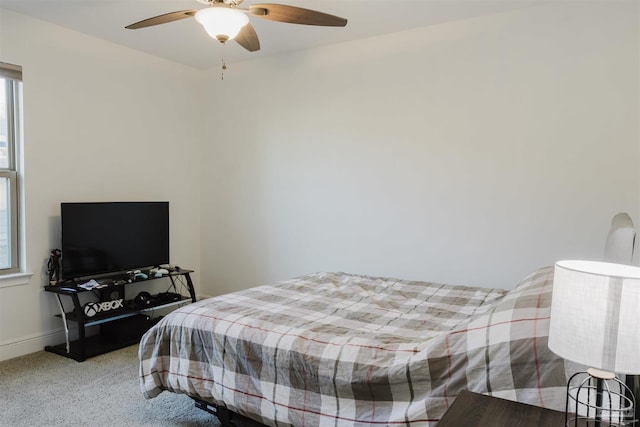 bedroom featuring carpet, multiple windows, and ceiling fan