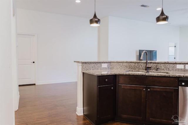 kitchen with dark brown cabinetry, light stone countertops, sink, and stainless steel dishwasher