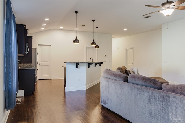 living room with dark hardwood / wood-style floors, ceiling fan, lofted ceiling, and sink