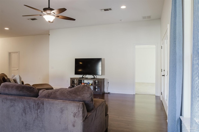 living room featuring dark hardwood / wood-style floors and ceiling fan