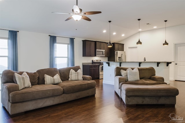 living room with vaulted ceiling, ceiling fan, and dark hardwood / wood-style floors